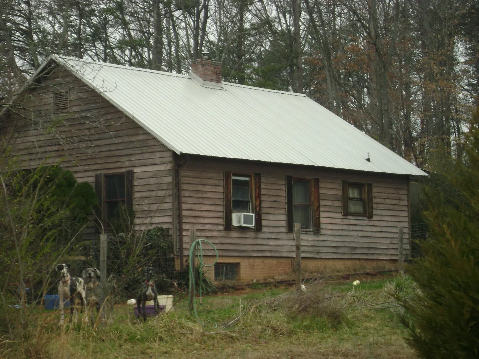 White metal roof on an old wood sided farmhouse, from a Metal Roof Installation job in Mount Arlington